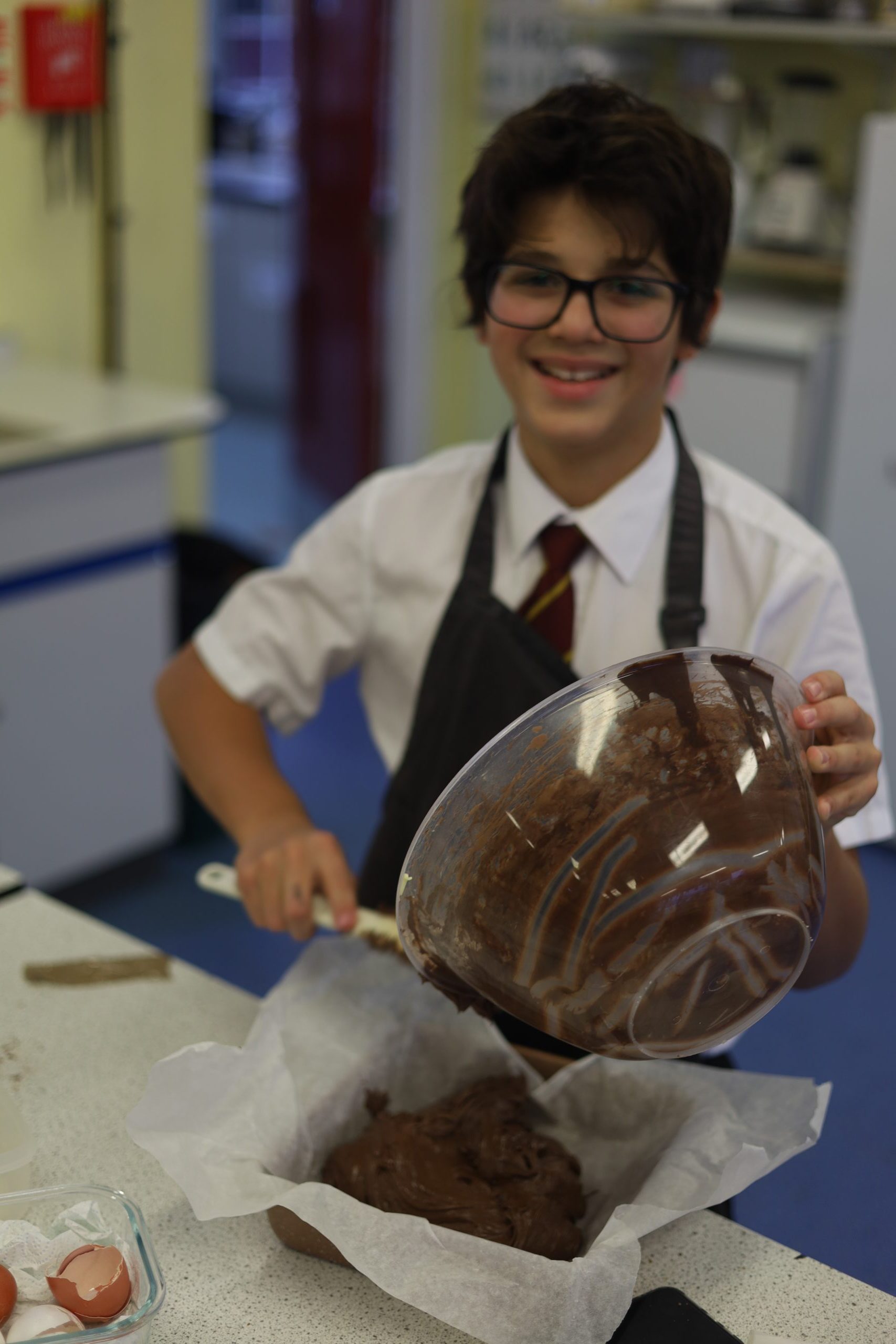 Young student enjoying baking and cooking classes at Kings School.